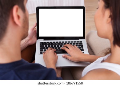 High angle view of young couple using laptop together at home