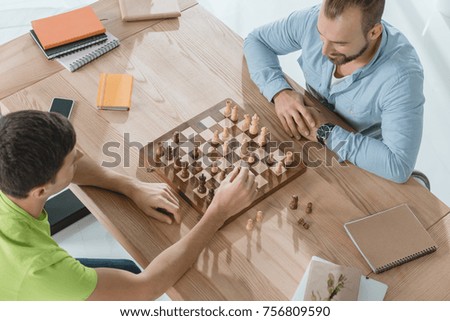 high angle view of young men playing chess
