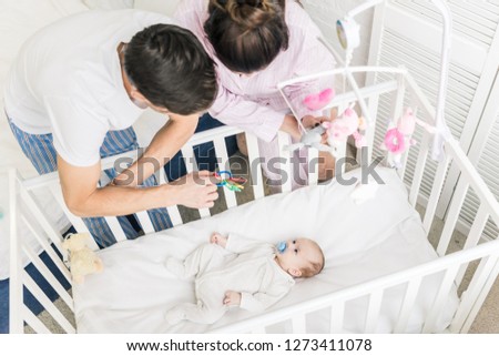 Similar – Relaxed mother and sons playing over the bed