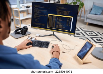 High angle view at young IT programmer writing code for mobile devices at home office workplace - Shutterstock ID 2285064071