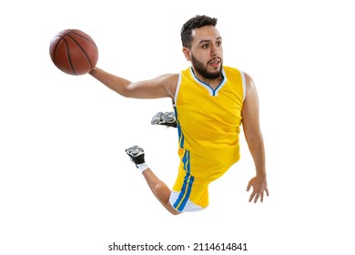 High angle view of young sportive man, professional basketball player jumping with ball isolated on white background. Sport, competition, hobby, active lifestyle. Motion, activity, movement concepts.