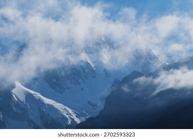 High cliffs at dawn in clouds and snow