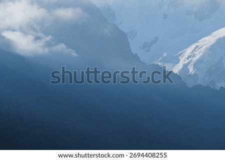 High cliffs at dawn in clouds and snow