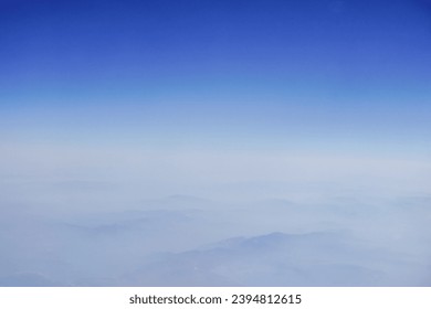 high clouds with dense fog and deep blue sky during a flight on vacation
