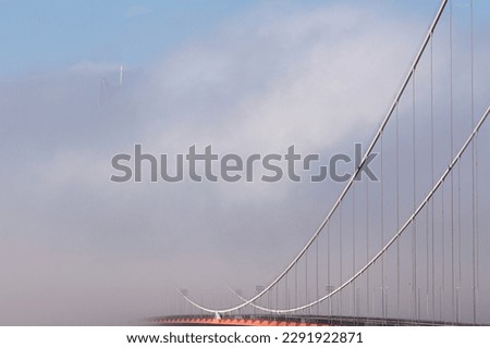 High Coast Bridge Sweden in fog and mist. The opposite background is hidden in the foggy weather. Modern suspension bridge above a river.