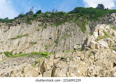 high coastal cliff formed by stone columns, Cape Stolbchaty on the island of Kunashir - Shutterstock ID 2216091229