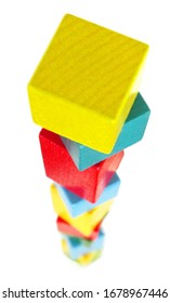 A High Colorful Block Tower Of Wooden Building Blocks. Fragile Balance. Isolated On A White Background. Top View.