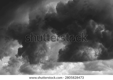 High contrast black and white dramatic storm clouds texture background. Powerful cloud formations with rich texture and moody lighting, perfect for weather and climate