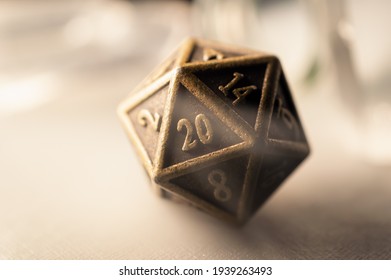 High contrast close-up image of a 20-sided role playing die surrounded by smoke.
