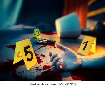 High contrast image of a bloody crime scene with a dead body and gun on the floor