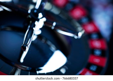 High contrast image of casino roulette and poker chips on bokeh background. Place for text. - Shutterstock ID 766680337