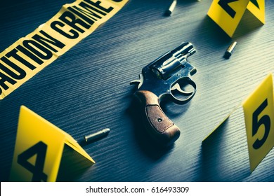 High Contrast Image Of A Crime Scene With Gun And Markers On The Floor