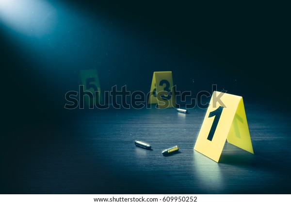 High contrast image of a crime scene with\
evidence markers