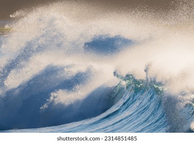 A high contrast image of a large wave backlit by the early morning sun 
