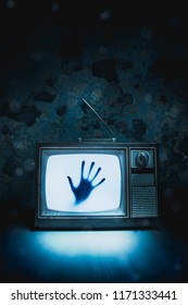 High contrast image of an old vintage TV with a hand inside - Shutterstock ID 1171333441
