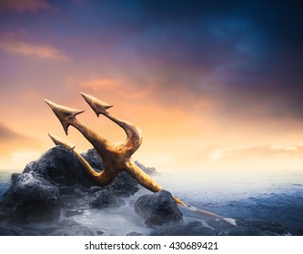 High Contrast Image Of Poseidon's Trident Resting On Some Rocks By The Sea