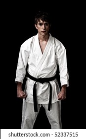 High Contrast karate male fighter on black background.