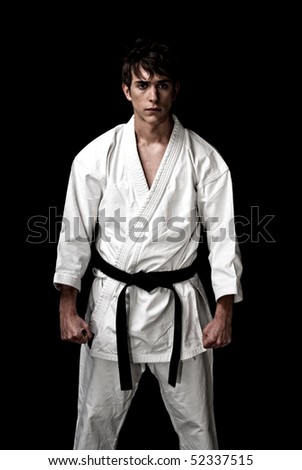 High Contrast karate male fighter on black background.