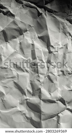 High contrast macro texture of white crumpled paper with harsh natural lighting and deep shadows, minimalist abstract background.