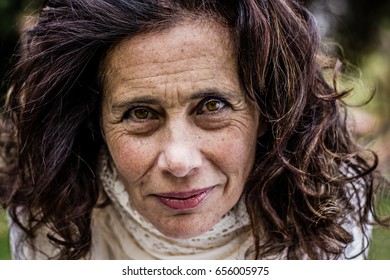 High contrast portrait of mature charming woman with intense deep look. Sensual young looking lady closeup. Wrinkles, skin care, middle aged person concepts - Shutterstock ID 656005975