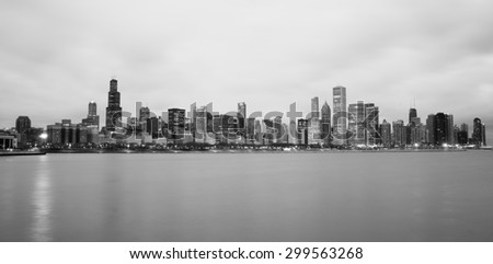 High contrast sunrise lights the long downtown Chicago skyline traditional black and white