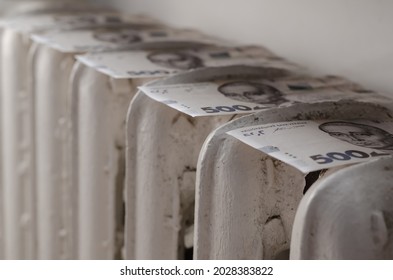 The High Cost Of Utilities Is A Concept. Money Lying On Top Of An Old Cast-iron Heating Battery. Ukrainian Five Hundred Hryvnia Bills. Selective Focus.