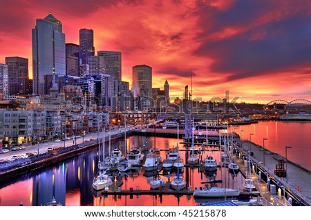 High dynamic image of Seattle skyline in dramatic sunrise colors across pier-66 waterfront