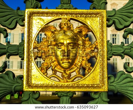 High dynamic range (HDR) Ancient baroque golden mask on the fence of the Royal Palace (Palazzo Reale) in Turin, Italy