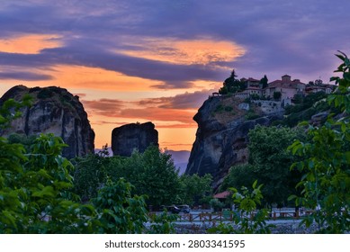 High dynamic range HDR landscape view of Meteora in central Greece, showcasing dramatic sandstone rock pillars rising above the Thessalian plain. The scene captures the unique geological formations topped with historic Orthodox monasteries, blending natural rock architecture with centuries-old spiritual heritage. Enhanced HDR detail reveals rich textures in the cliffs, valleys, and surrounding vegetation under dynamic lighting conditions. Meteora is a UNESCO World Heritage Site and one of Greece’s most iconic landscapes, known for its striking vertical rock formations and monastic settlements. The image emphasizes depth, contrast, and atmosphere, making it ideal for themes of travel, tourism, nature, geology, culture, and landscape photography