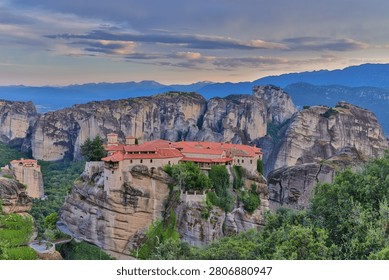 High dynamic range HDR landscape view of Meteora in central Greece, showcasing dramatic sandstone rock pillars rising above the Thessalian plain. The scene captures the unique geological formations topped with historic Orthodox monasteries, blending natural rock architecture with centuries-old spiritual heritage. Enhanced HDR detail reveals rich textures in the cliffs, valleys, and surrounding vegetation under dynamic lighting conditions. Meteora is a UNESCO World Heritage Site and one of Greece’s most iconic landscapes, known for its striking vertical rock formations and monastic settlements. The image emphasizes depth, contrast, and atmosphere, making it ideal for themes of travel, tourism, nature, geology, culture, and landscape photography