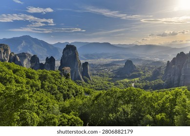High dynamic range HDR landscape view of Meteora in central Greece, showcasing dramatic sandstone rock pillars rising above the Thessalian plain. The scene captures the unique geological formations topped with historic Orthodox monasteries, blending natural rock architecture with centuries-old spiritual heritage. Enhanced HDR detail reveals rich textures in the cliffs, valleys, and surrounding vegetation under dynamic lighting conditions. Meteora is a UNESCO World Heritage Site and one of Greece’s most iconic landscapes, known for its striking vertical rock formations and monastic settlements. The image emphasizes depth, contrast, and atmosphere, making it ideal for themes of travel, tourism, nature, geology, culture, and landscape photography