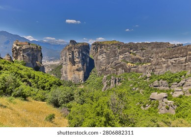 High dynamic range HDR landscape view of Meteora in central Greece, showcasing dramatic sandstone rock pillars rising above the Thessalian plain. The scene captures the unique geological formations topped with historic Orthodox monasteries, blending natural rock architecture with centuries-old spiritual heritage. Enhanced HDR detail reveals rich textures in the cliffs, valleys, and surrounding vegetation under dynamic lighting conditions. Meteora is a UNESCO World Heritage Site and one of Greece’s most iconic landscapes, known for its striking vertical rock formations and monastic settlements. The image emphasizes depth, contrast, and atmosphere, making it ideal for themes of travel, tourism, nature, geology, culture, and landscape photography