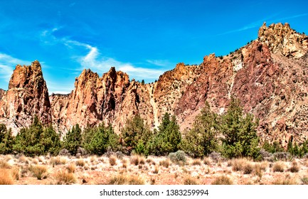 High Dynamic Range Wide Angle View Of Smith Rock State Park Juniper Treeline Against A Deep Jewel Tone Blue Sky In Central Oregon 