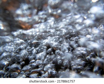 High Energy Abstract Image Shows Bubbles Flowing Past Colorful Stones. Shot Underwater In Natural Light With Flash, No People, Closeup With Defocused Copy Space. Texture And Dramatic Motion.