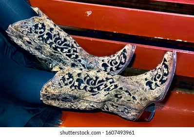 High Fashion Cowgirl Boots On Red Bench.