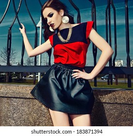 High Fashion Look.glamor Beautiful Sexy Stylish Brunette Caucasian Young Woman Model In Red Colorful Cloth With Bright Makeup Outdoors In The Street In Vogue Style