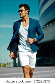 High Fashion Look.Young Stylish Confident Happy Handsome  Businessman Model Man In Blue Suit Cloth Lifestyle In The Street In Sunglasses Behind Sky