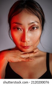 High Fashion Model Asian Woman In Neon Colorful Bright Lights Posing In Studio, Portrait Of A Beautiful Sexy Girl With Trendy Makeup