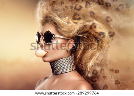 High Fashion Model Girl Portrait wearing sunglasses. Beauty Woman with Holiday Leopard Makeup, Beautiful accessories. Modern updo hair style. Bubble Gum