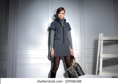 High fashion model holding bag posing wooden ladder in the studio  - Shutterstock ID 229586188