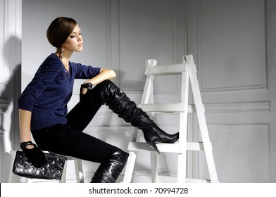 High Fashion Model Sitting Cube Posing Wooden Ladder In The Studio