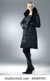 High Fashion Model In Winter Fur Coat Clothes Posing In The Studio