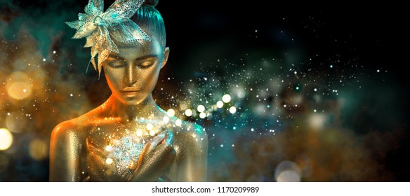 High Fashion model woman in colorful bright golden sparkles and neon lights posing with fantasy flower, portrait of beautiful girl glowing make-up. Art design colorful make up. Glitter Vivid neon skin