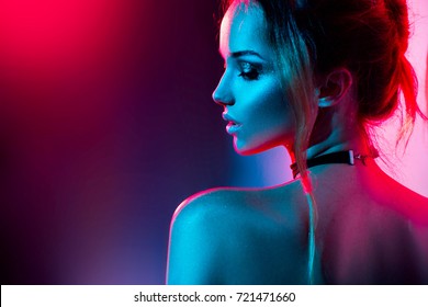 High Fashion model woman in colorful bright lights posing, portrait of beautiful  girl with trendy make-up. Art design, colorful make up. Over colourful vivid background. 