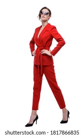 High Fashion Photo Of A Beautiful Elegant Young Woman In A Pretty Red Suit, Jacket, Pants, Trousers And Sunglasses Posing Over White Background. Slim Figure. Studio Shot. Businesswoman