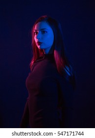 High Fashion Portrait Of Elegant Woman In Black Dress. Bright Makeup, Dark Background. Studio Shot.