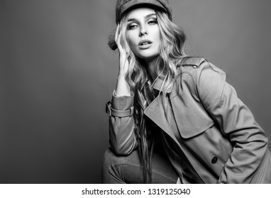High Fashion Portrait Of Stylish Blond Woman In Total Beige Look With Leather Bag And Animal  Print Belt.