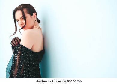 High fashion portrait of young beautiful brunette woman wearing nice trendy summer polka-dot dress and gloves.Sexy fashion model posing near light blue wall in studio.Fashionable female - Shutterstock ID 2095144756