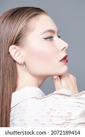 High Fashion Shot. Beautiful Female Model Posing In Profile In An Elegant Haute Couture Blouse And Bright Makeup On Her Face. Make-up And Hairstyle. Sideview Portrait. 