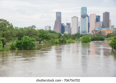 High and fast water rising in Bayou River along Allen Parkway and Memorial Drive with downtown Houston in background under storm cloud sky. Heavy rains from tropical storm caused many flooded areas - Shutterstock ID 706756702